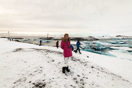 A women posing in Jokulsarlon is a glacial lagoon or better known as Iceberg Lagoon which located in Vatnajokull National Park Iceland