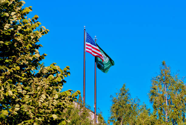 U.S. Flag and Saudi Arabian Flag Flying Together Herndon, Virginia, USA - September 19, 2023: A United States flag and a Saudi Arabian flag fly abreast at the King Abdullah Academy, a K-12 private school in Northern Virginia. herndon virginia stock pictures, royalty-free photos & images