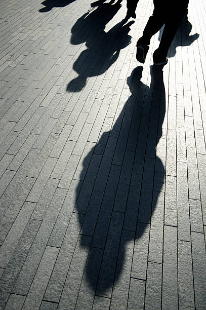 istock Businessman Shadows Walk on Smooth Modern Background 170522295