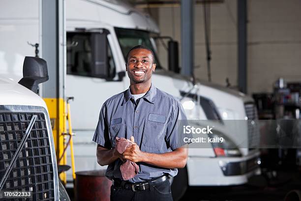 Mechanic In Garage With Semitruck Stock Photo - Download Image Now - Mechanic, Truck, Repairing