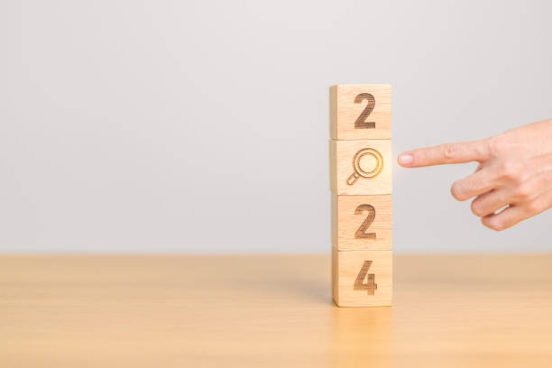 istock 2024 block with magnifying glass icon. SEO, Search Engine Optimization, hiring , Advertising, Idea, Strategy, marketing, Keyword, Content and New Year start concepts 1705248769