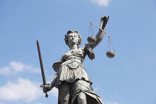 istock scales sword and  blue sky with ancient lady Justice Justitia 170525881