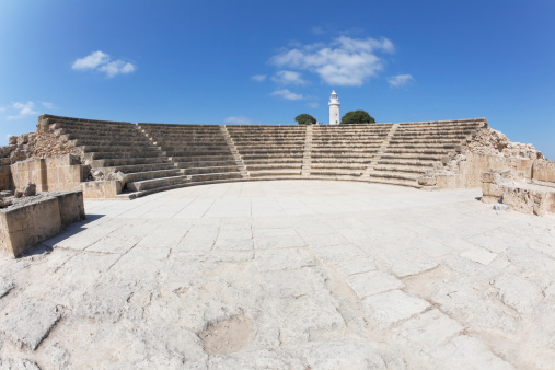 Paphos amphitheater and white lighthouse against blue sky Cyprus wide angle fisheye picture