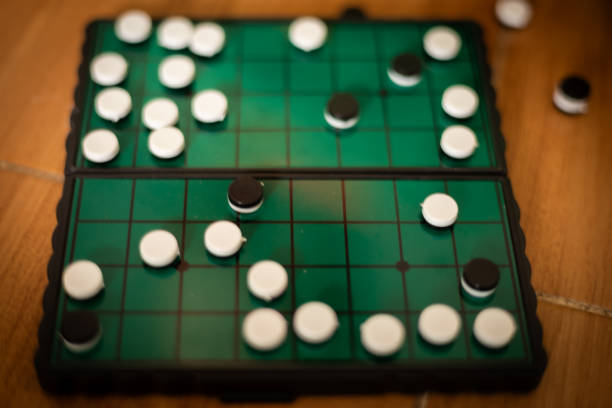istock White and black stones are placed on a wooden board for playing Go. 1705260942