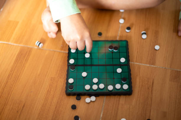 White and black stones are placed on a wooden board for playing Go.