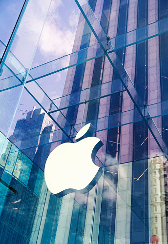 New York City, United States - September 27, 2016: Glass building of the Apple Store with huge Apple Logo at 5th Avenue near Central Park. The store is designed as the exterior glass box above the underground display room