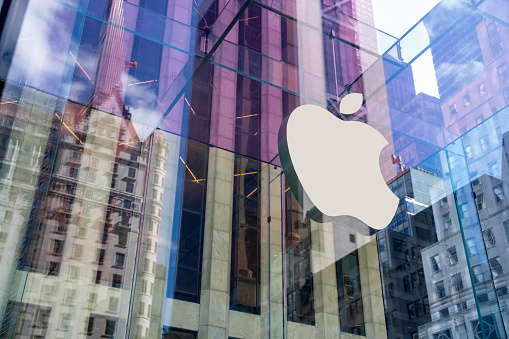 New York City, United States - September 27, 2016: Glass building of the Apple Store with huge Apple Logo at 5th Avenue near Central Park. The store is designed as the exterior glass box above the underground display room