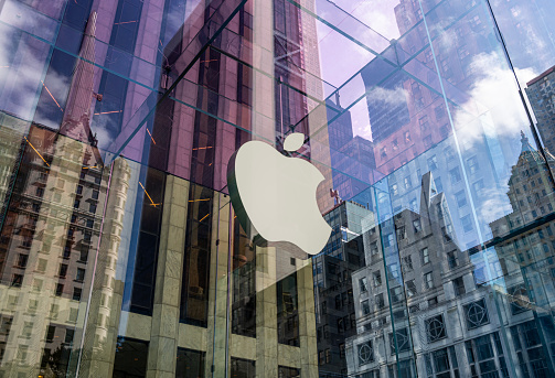 New York City, United States - September 27, 2016: Glass building of the Apple Store with huge Apple Logo at 5th Avenue near Central Park. The store is designed as the exterior glass box above the underground display room