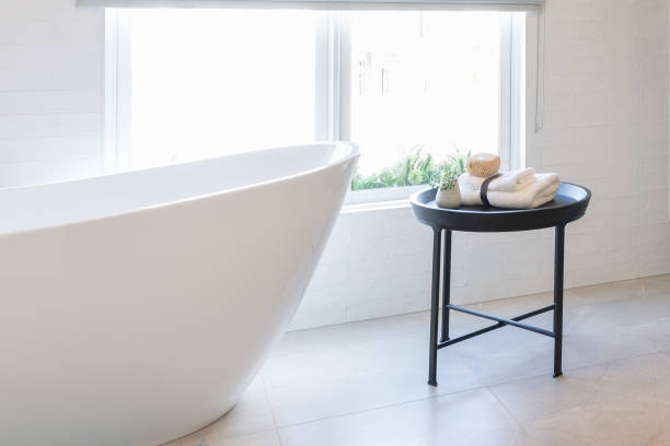 istock Cropped view of ceramic white bathtub in modern bathroom. Interior design idea. Home spa relaxation concept. 1705320828