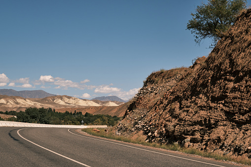Empty winding road through mountain ridge