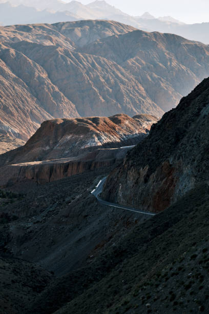 istock Mountain range above winding road in Tien Shan mountains 1705349076