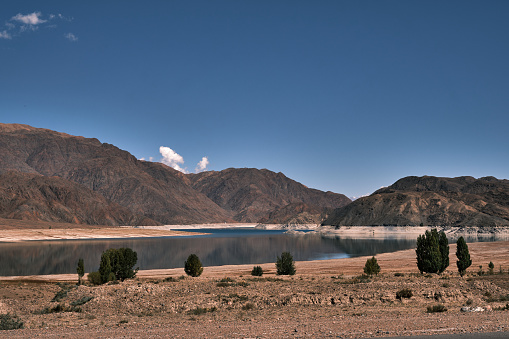 View of mountain lake (Orto-Tokoy reservoir) on sunny autumn day