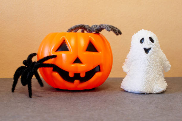 istock Jack-O'-Lantern pumpkins, ghost and spiders on Halloween 1705378573
