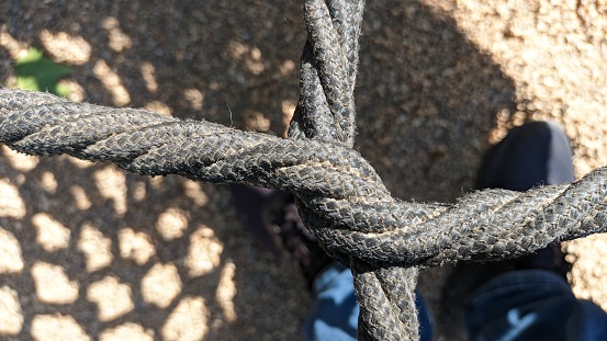 Braided cells web of black thick rope The central part of the swing for children photo