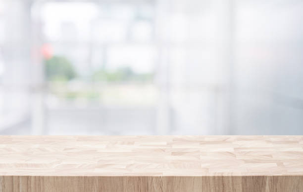 istock Selective focus.Top of  end grain wood  table with blur window glass building background. 1705393933