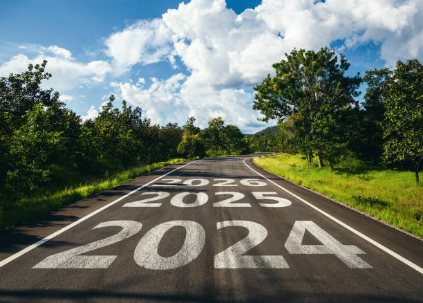 New year 2024 to 2026 written on the road in the middle of asphalt road. New year 2024 to 2026 written on the road in the middle of asphalt road, Planning of new year concept. nature calendar stock pictures, royalty-free photos & images