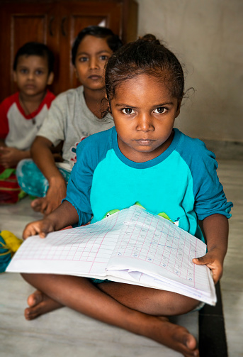 Education – group of rural Indian kids studying in the classroom.