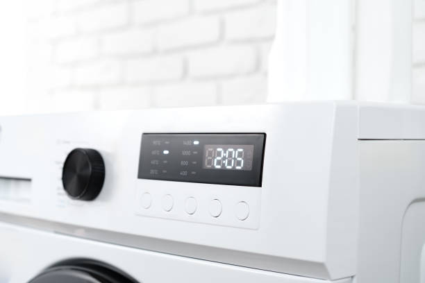 istock Modern white washing machine in a laundry room 1705435970