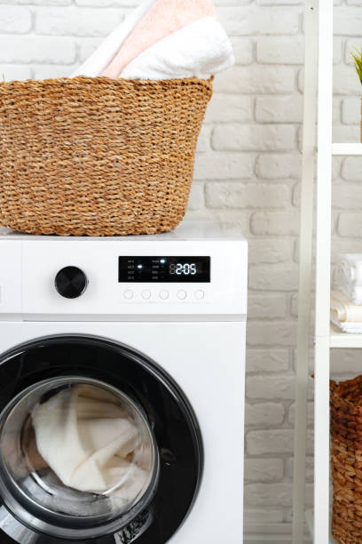 istock Laundry basket on washing machine in a laundry room 1705456729