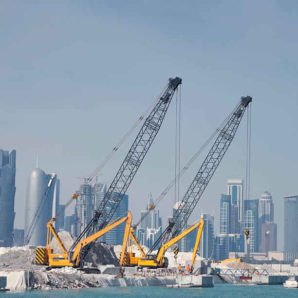 Construction in Doha Construction work in Doha, Qatar. construction skyscraper machine industry stock pictures, royalty-free photos & images