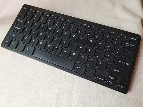 Wireless keyboard which is convenient for working was placed beside the wall