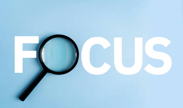 istock A magnifying glass on the floor shows the word FOCUS. 1705485716
