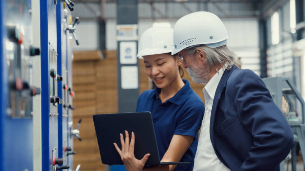 istock Professional male industrial engineers talk with factory worker while using laptop in manufacturing factory. Working in manufacturing plant or production plant. 1705488552