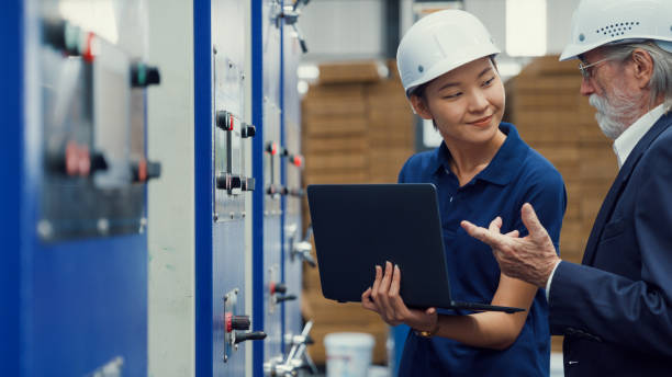 istock Professional male industrial engineers talk with factory worker while using laptop in manufacturing factory. Working in manufacturing plant or production plant. 1705488553