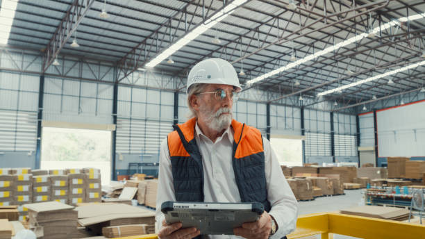 istock Professional male industrial engineers use tablet while standing in manufacturing factory. Working in manufacturing plant or production plant. 1705489088