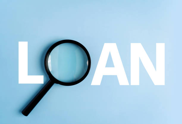 istock Loan word created with magnifying glass on blue background 1705490704
