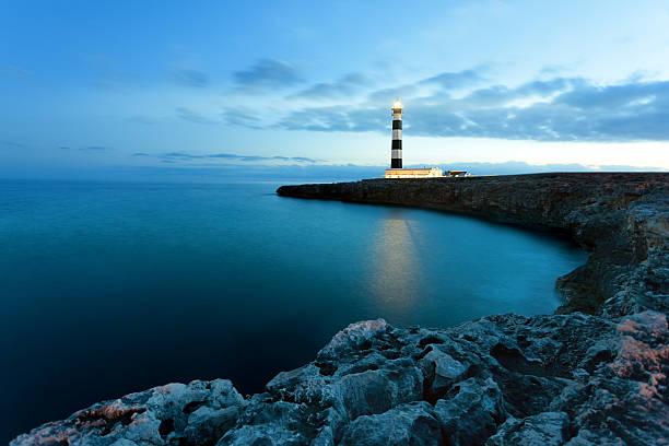 Lighthouse Mediterranean lighthouse in Menorca. Far de Artrutx. Minorca. Spain. lighthouse lighting equipment reflection rock stock pictures, royalty-free photos & images