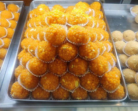 Boondi Laddu is an Indian sweet prepared from the boondi snack or besan or chickpea flour pearls. Deep fried boondi pearls are soaked in a sugar syrup and shaped into round balls or Indian Laddu.
