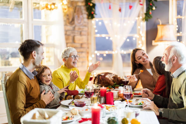 istock Happy multi-generation family enjoying in conversation during Thanksgiving lunch at dining table. 1705499505