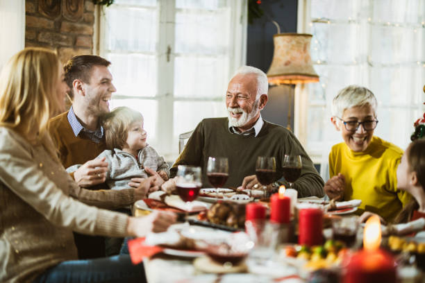 istock Happy multi-generation family talking during a meal at dining table. 1705501619