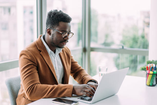 istock Successful businessman in modern office working on laptop. 1705503932
