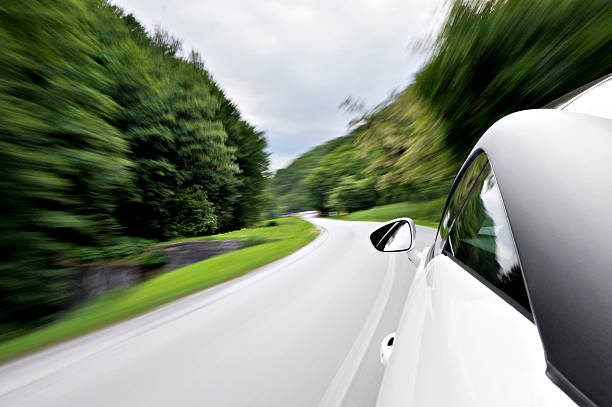 Motion blur shot of drive with a sports coupe