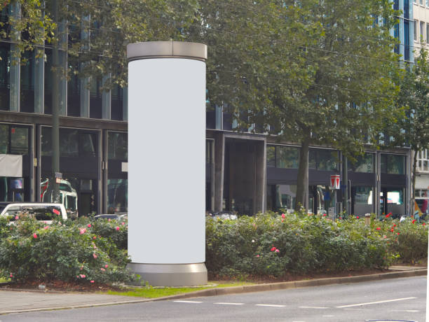 Empty advertising pillar in a city with grey  free copy space, promotion mock up. Blank advertising panel