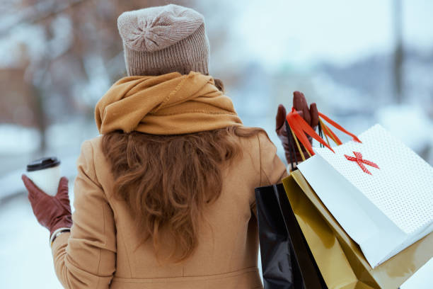 Seen from behind woman in brown hat and scarf stock photo