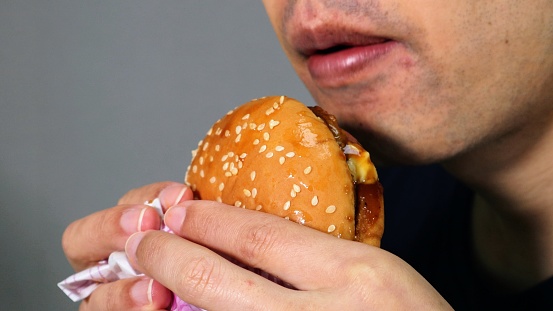 Close-up photo of a person eating a hamburger