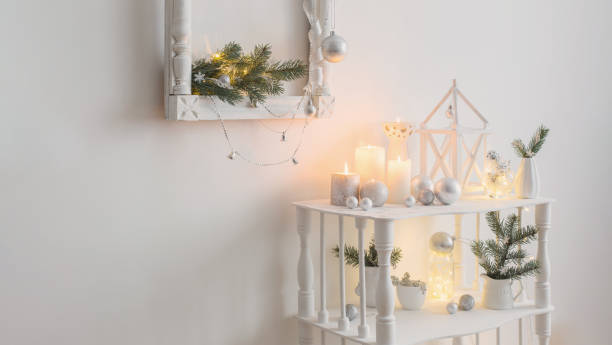istock Christmas decoration with candles on background  white wall 1705514351