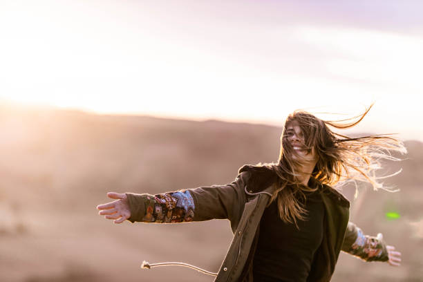 istock Happy woman having fun while spinning in autumn day. 1705518721