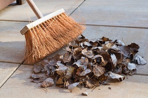 Seasonal cleaning - broom and dry leaves