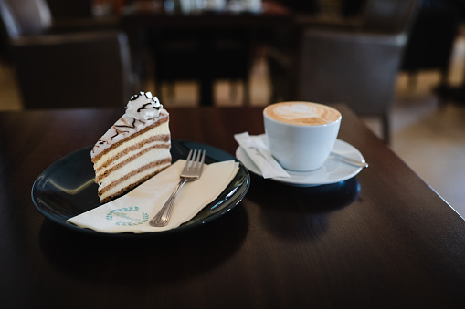 Coffee cup and a slice of cake