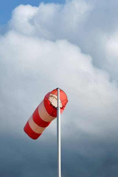 istock A red and white striped windsock against a stormy sky 1705536679