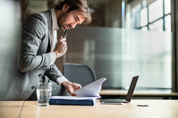 istock Young businessman going through paperwork in the office. 1705541362