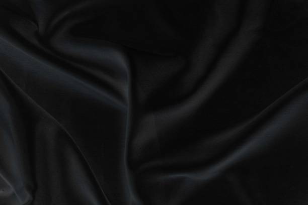 istock Smooth elegant black silk fabric or satin luxury cloth texture for abstract background 1705543152