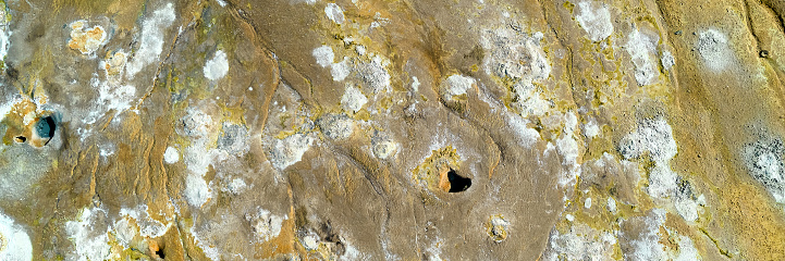 Detail of an Italian Marble quarry or open cast mine pit showing the rock face where the stone is excavated in blocks for construction and sculpture in Carrara, Italy