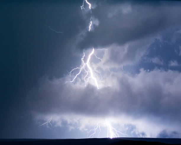 istock Lightning storm in blue light. Electrical discharges in nature. 1705559764