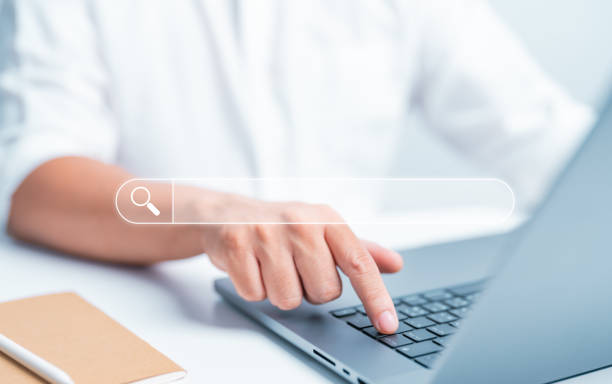 istock Businessman press enter button on computer laptop with a search bar to Search for information. Internet Data Browsing, Search Engine Optimization, or SEO. Finding knowledge or information on website. 1705565660