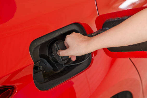 istock Open the fuel cap in a red car 1705566881